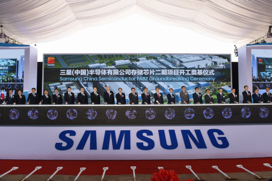 지난해 3월 열린 삼성전자 중국 반도체 시안 2기 라인 기공식에서 주요 참석자들이 기념 세레모니를 하고 있다. <삼성전자 제공>